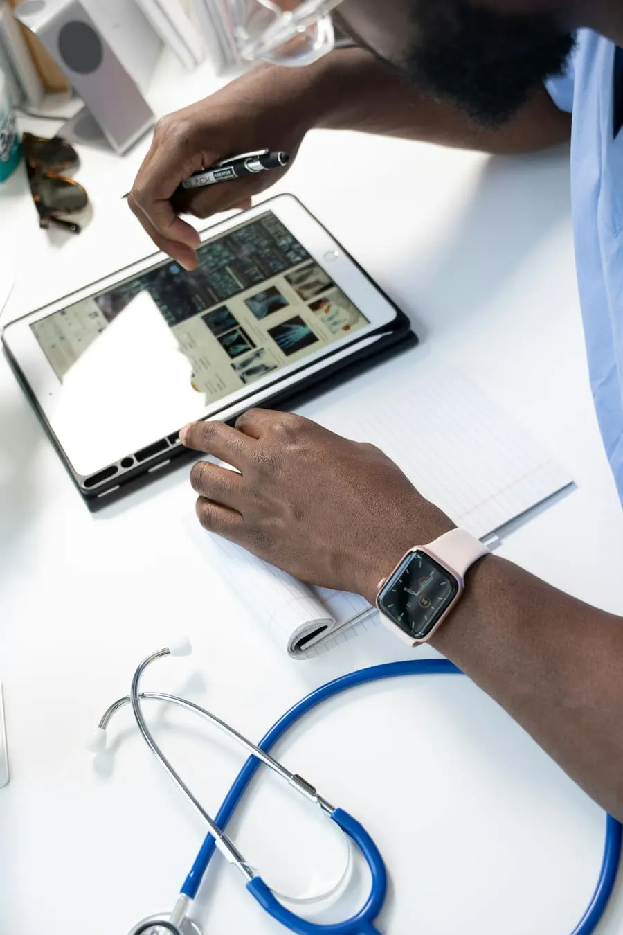 A clinician reviewing a patient’s medical data on a tablet